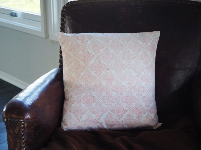 hand block printed cushion in coral terracotta pink