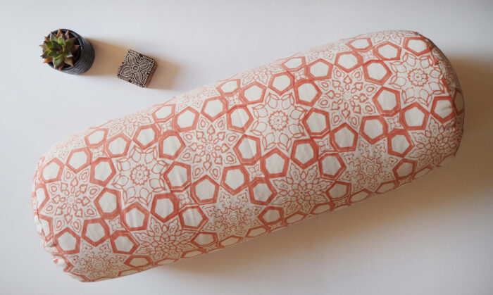 Yogipod Jaipur Pink Fretwork yoga bolster with a plant