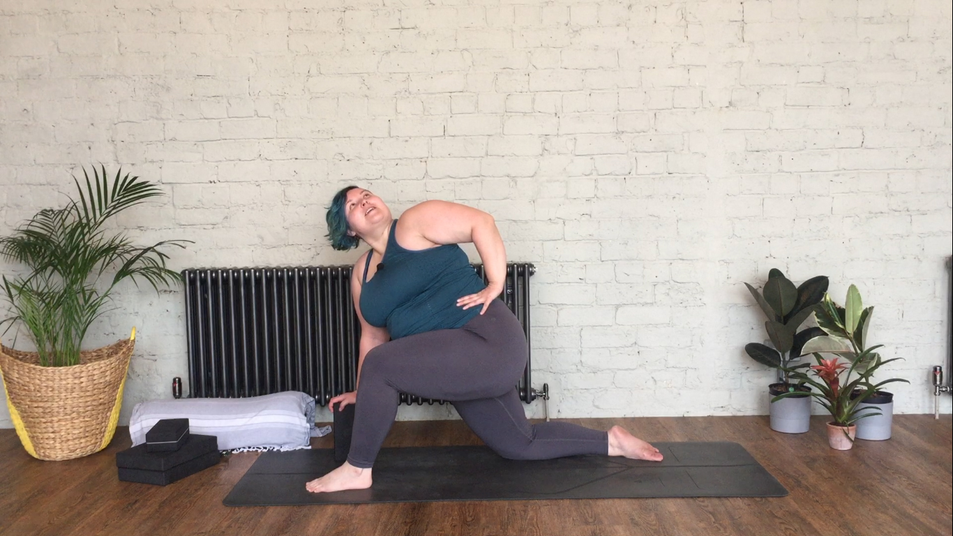 Sarah uses a block under her hand to support a revolved twisted lunge