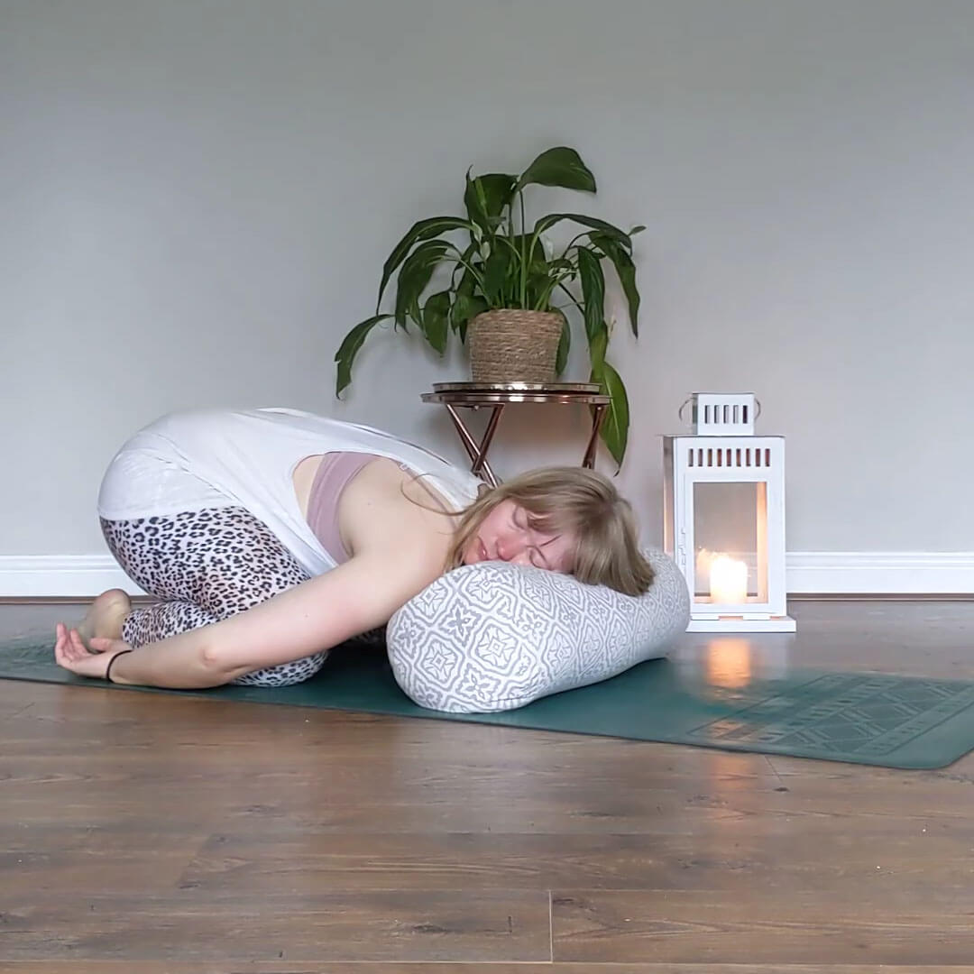 resting childs pose using a yogipod yoga bolster