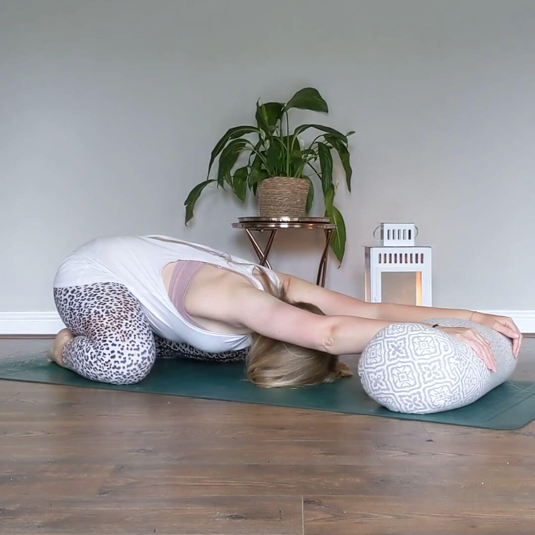 Childs pose using a yogipod yoga bolster under the hands