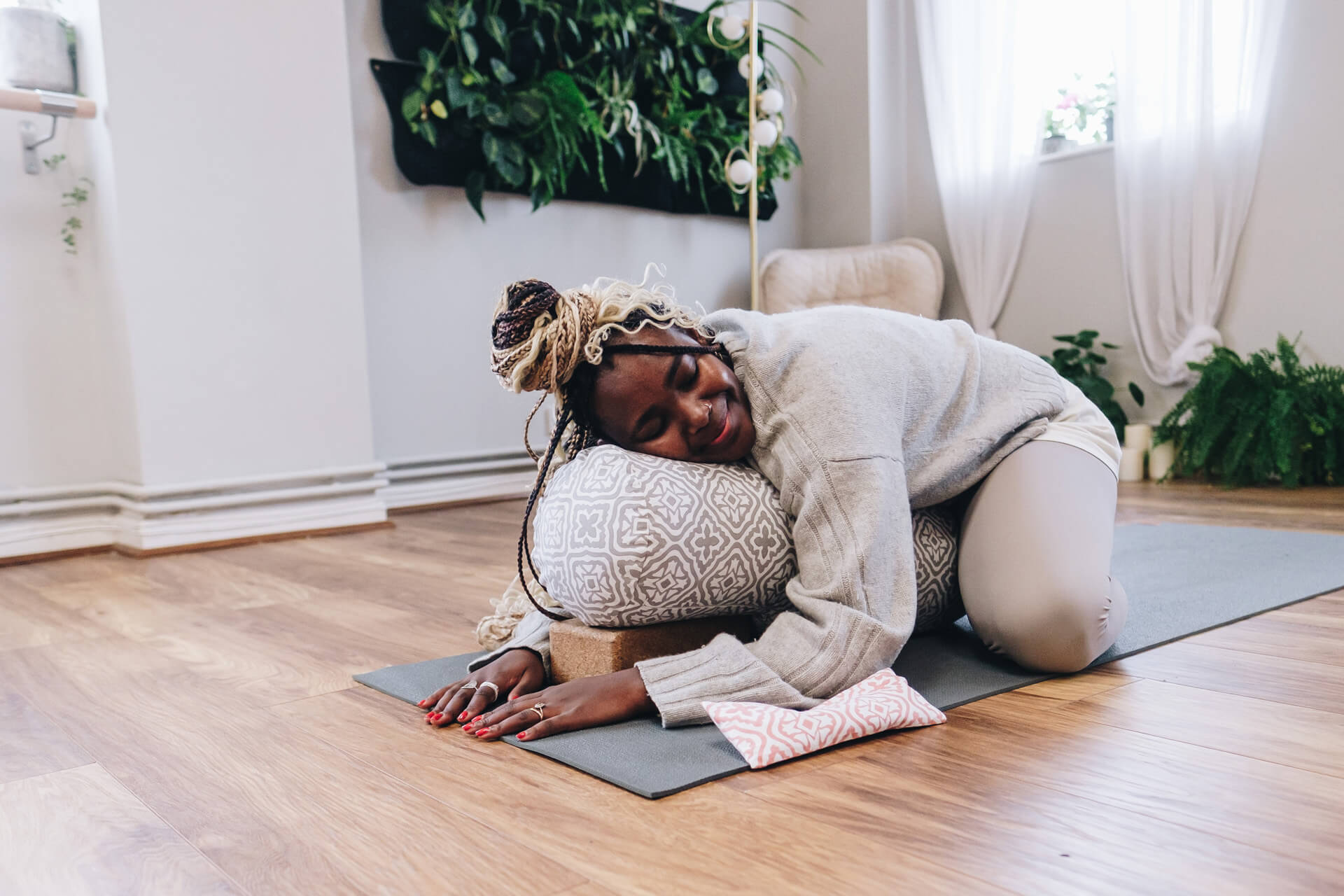 Ennette Lainchbury practices childs pose using a Yogipod bolster