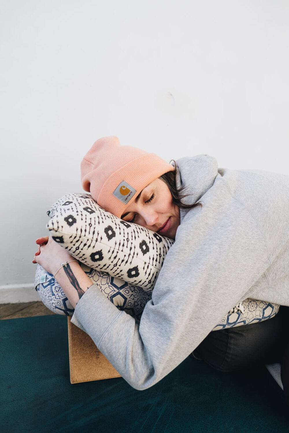 Harriet McAtee rests while hugging a yoga bolster