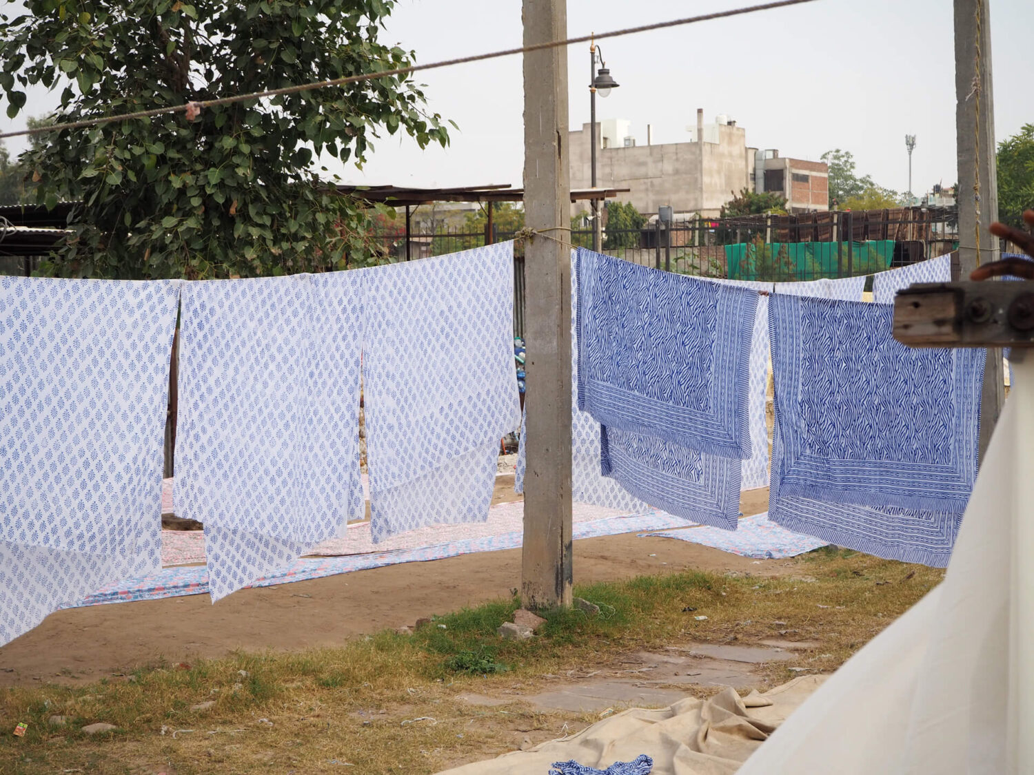 Block print fabric drying on racks