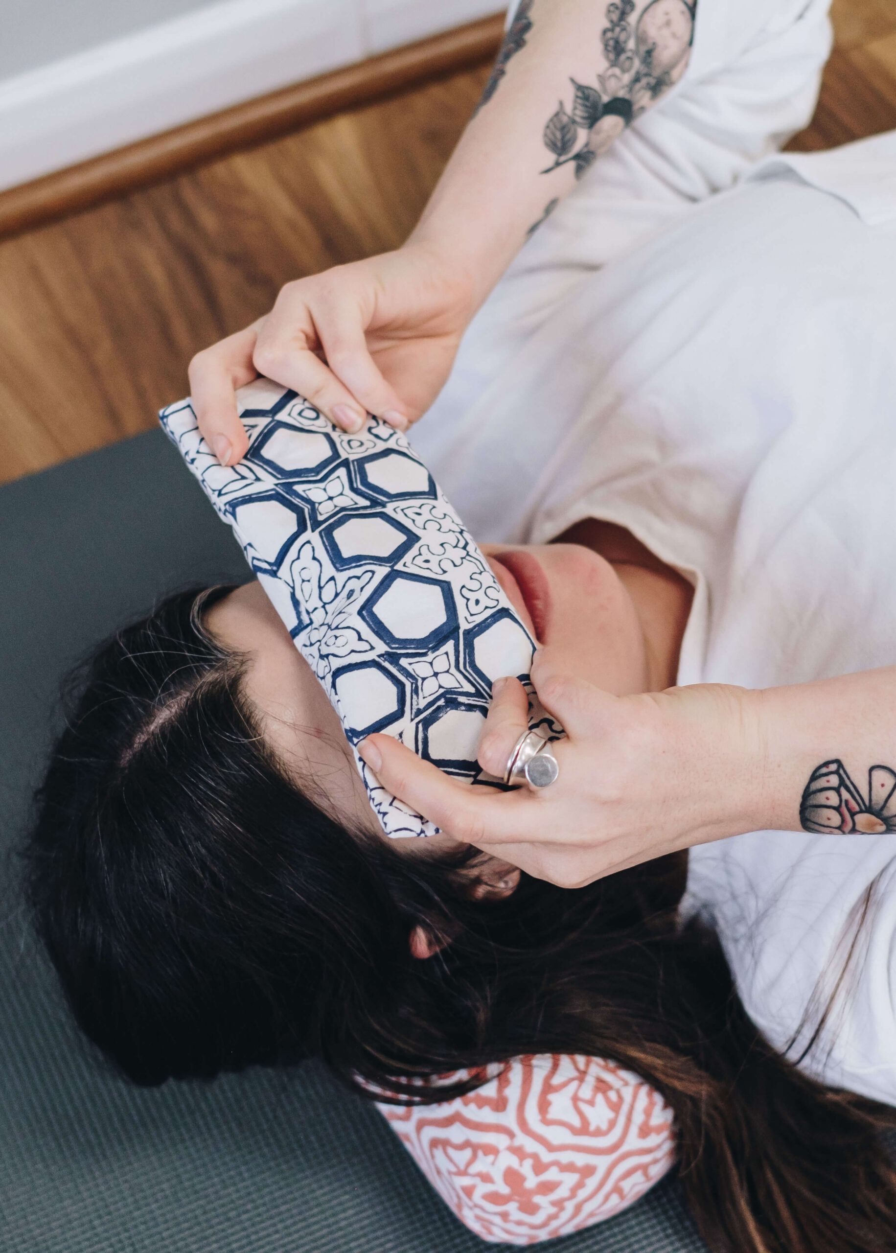 harriet relaxes at the end of a yoga class with a yogipod eye pillow